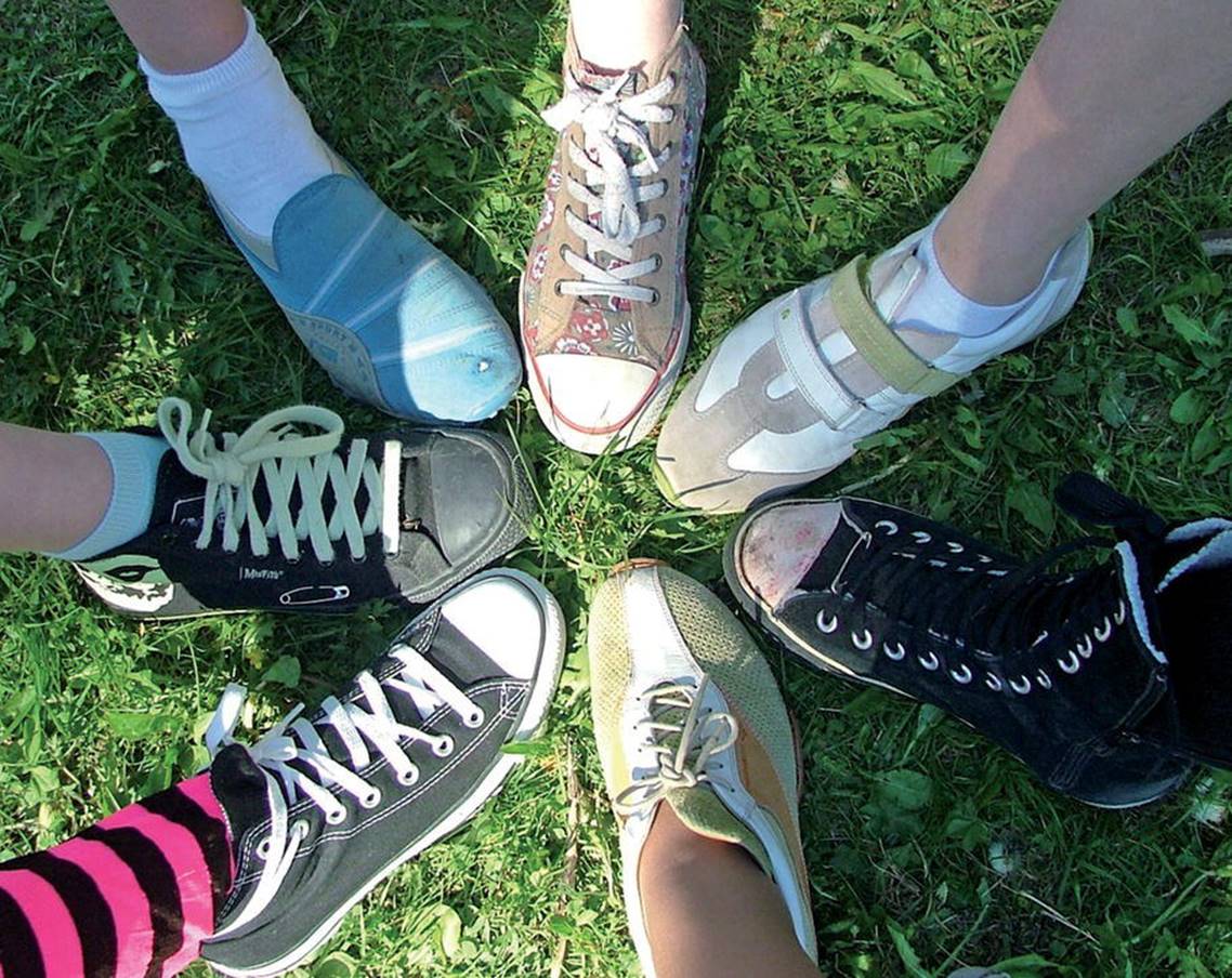 Photo displaying top view of seven different shoes in circle.